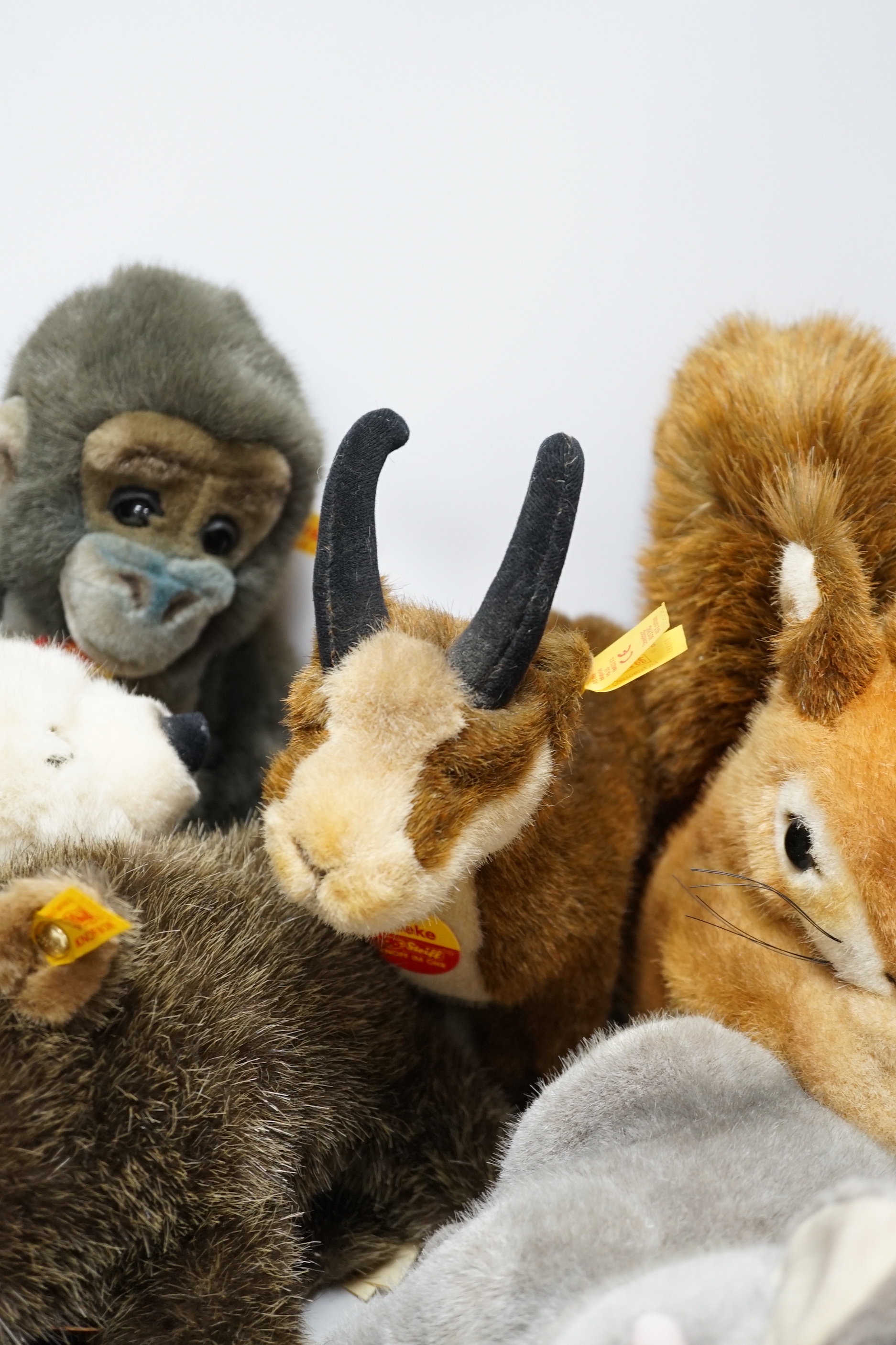Thirteen Steiff yellow tag animals and one yellow tag bear, including Snorry fox, Mannie rabbit, Nagy beaver and Resi cow